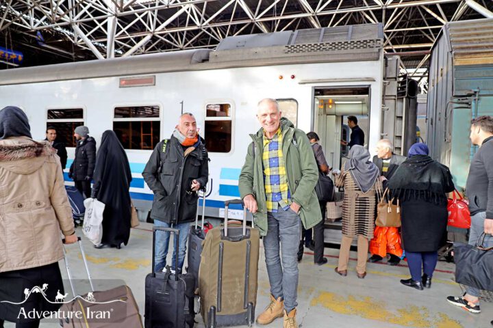 two tourists on Iranian Train station with luggage