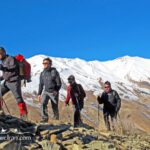 Hikers trekking snowy mountain trails- Iran untraveled routes