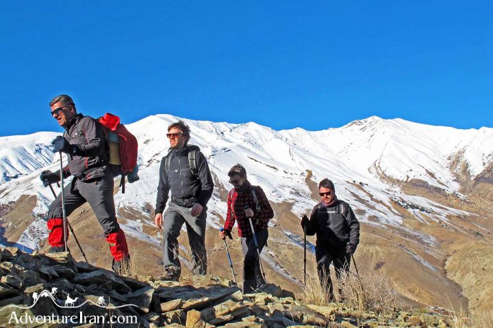 Hikers trekking snowy mountain trails- Iran untraveled routes