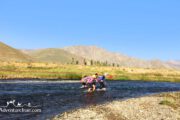 Hikers crossing river- Iran Off the Beaten Routes