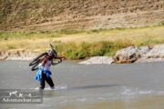 Biker crossing river- Iran adventure