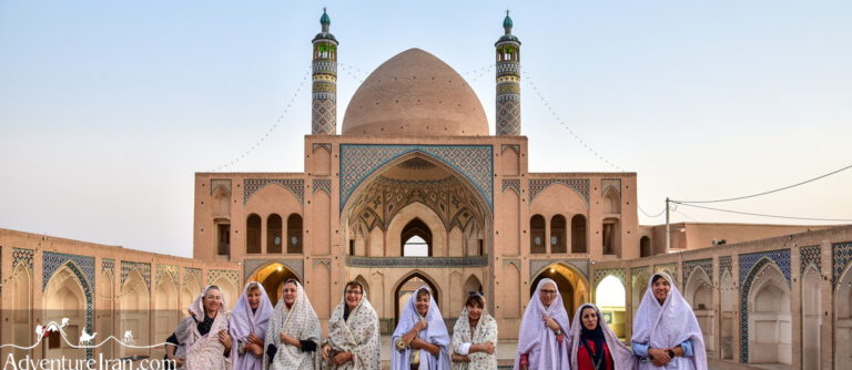 Ladies group photo in Iran with mosque